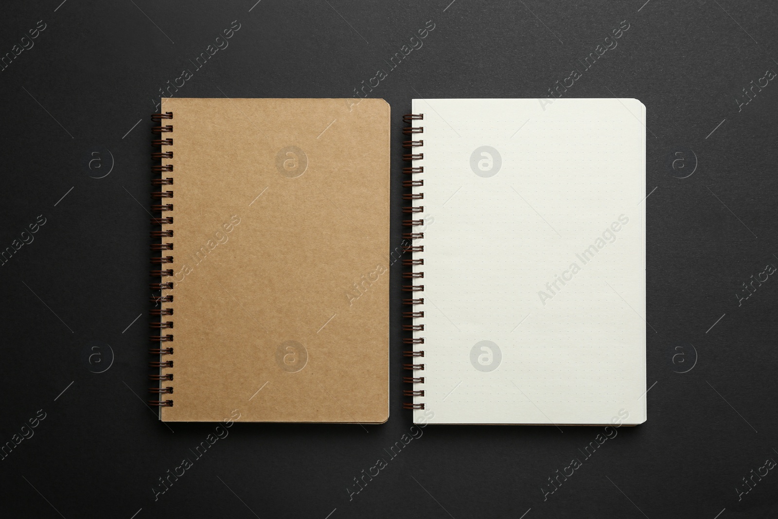 Photo of Two notebooks on black background, top view