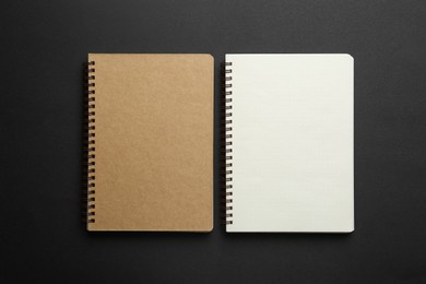 Photo of Two notebooks on black background, top view