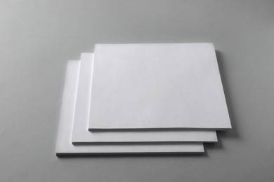 Photo of Stack of blank paper sheets for brochure on light grey background