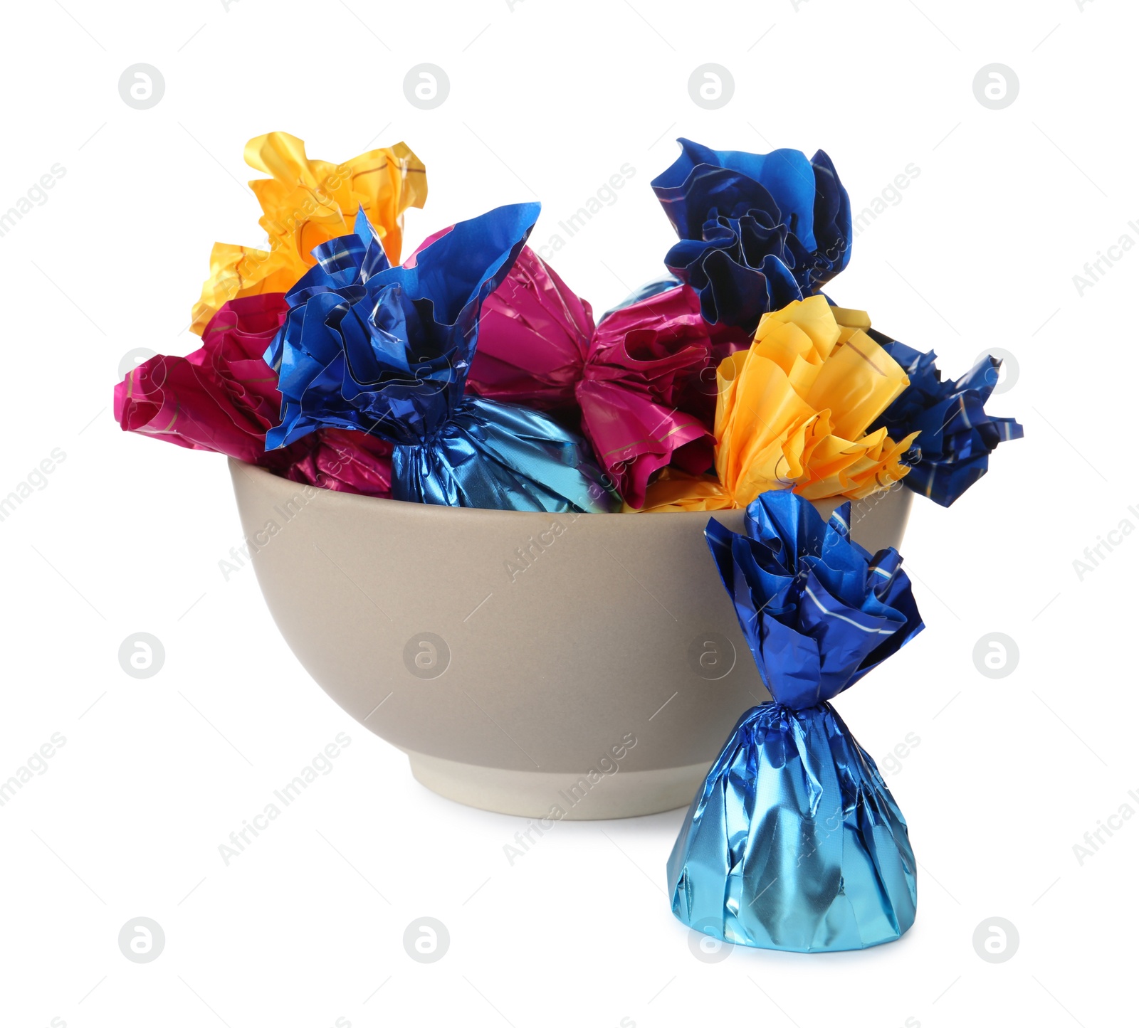 Photo of Bowl with candies in colorful wrappers isolated on white