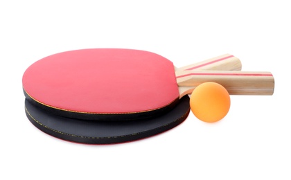 Photo of Orange plastic ball and rackets for table tennis on white background