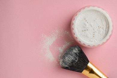 Rice loose face powder and makeup brush on pink background, flat lay. Space for text