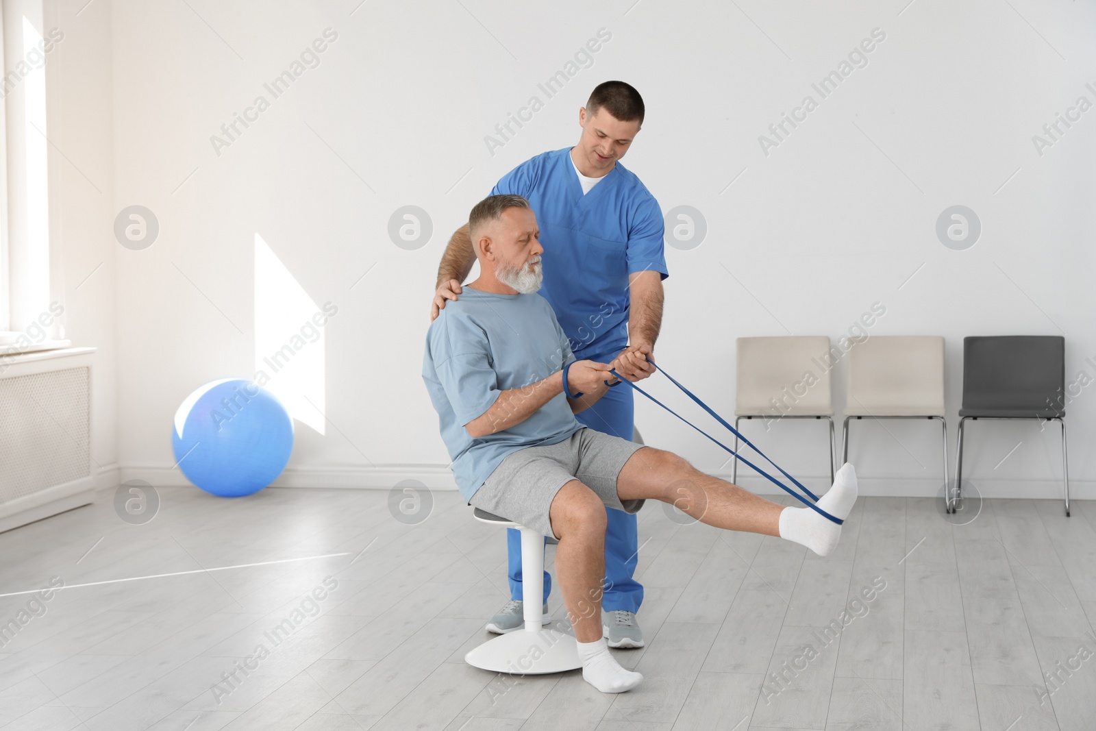 Photo of Professional physiotherapist working with senior patient in rehabilitation center