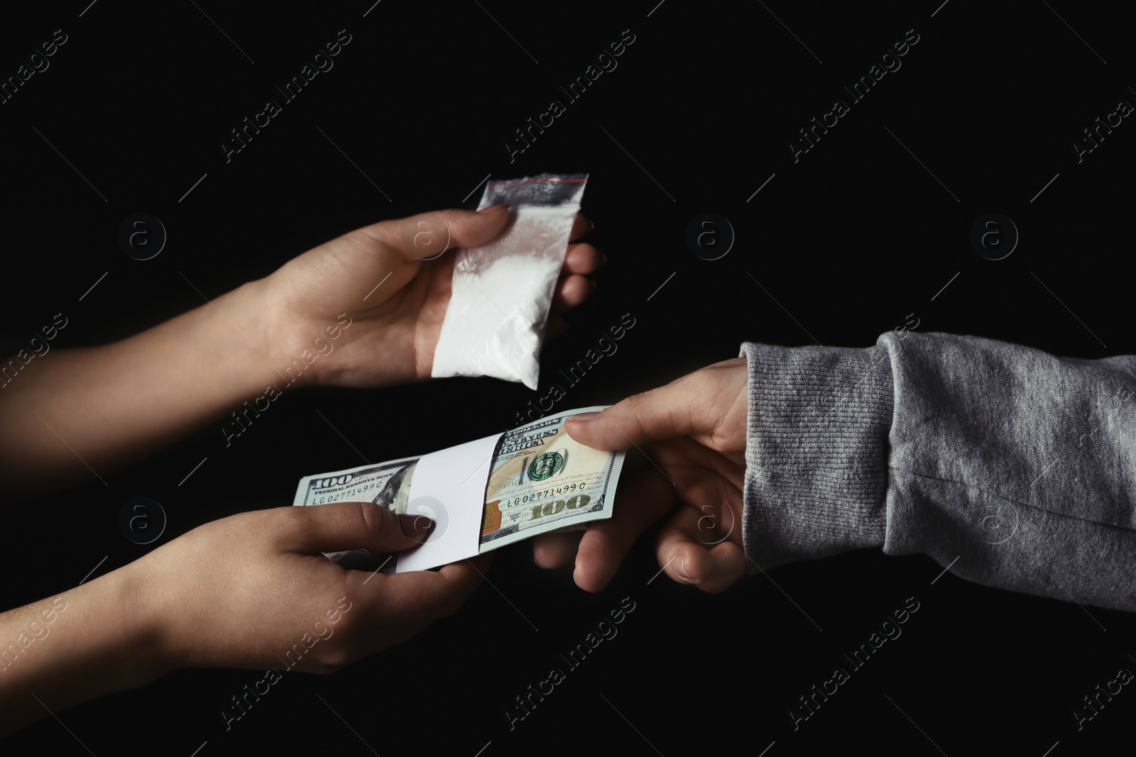 Photo of Drug dealer selling cocaine to addict on black background, closeup