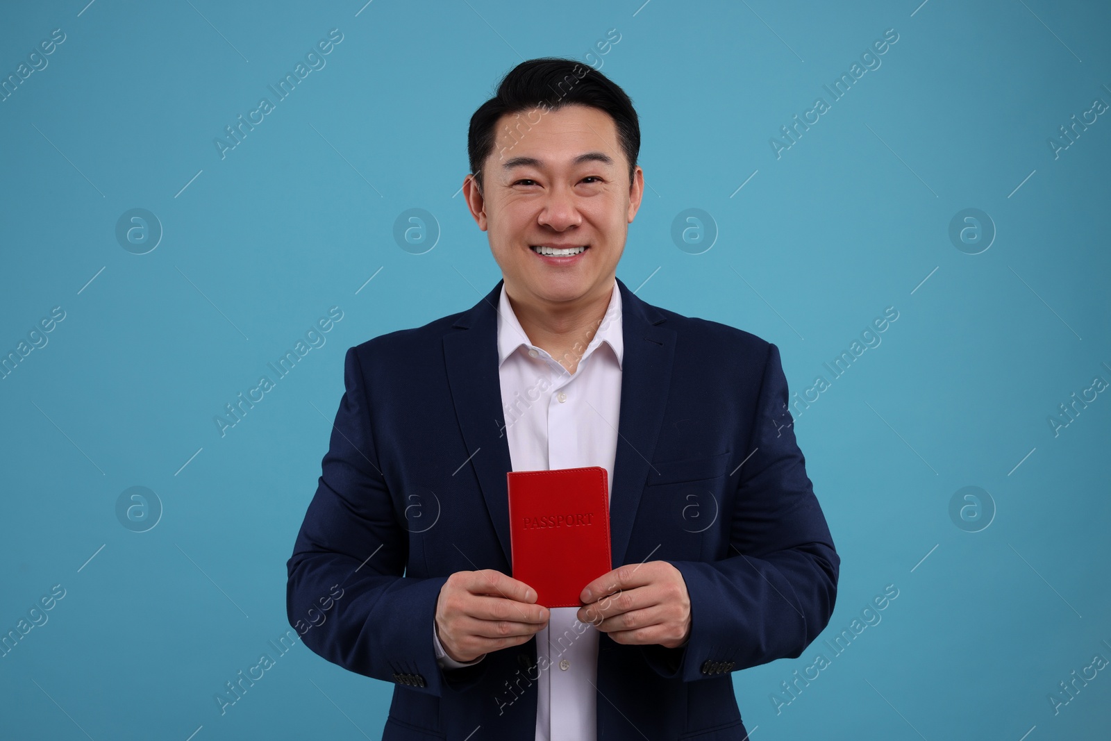 Photo of Immigration. Happy man with passport on light blue background