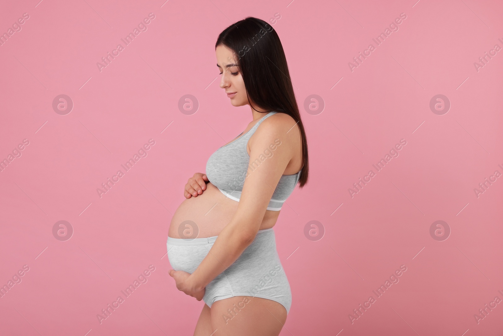 Photo of Beautiful pregnant woman in comfortable maternity underwear on pink background