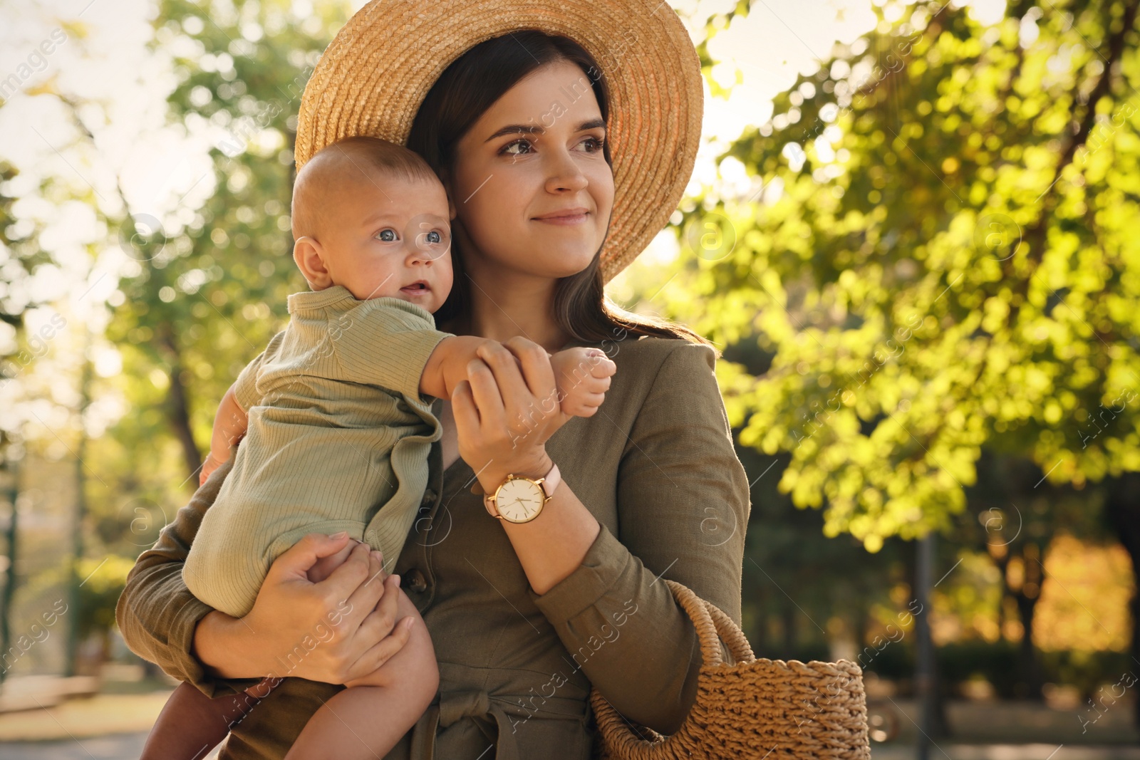 Photo of Young mother with her cute baby in park on sunny day