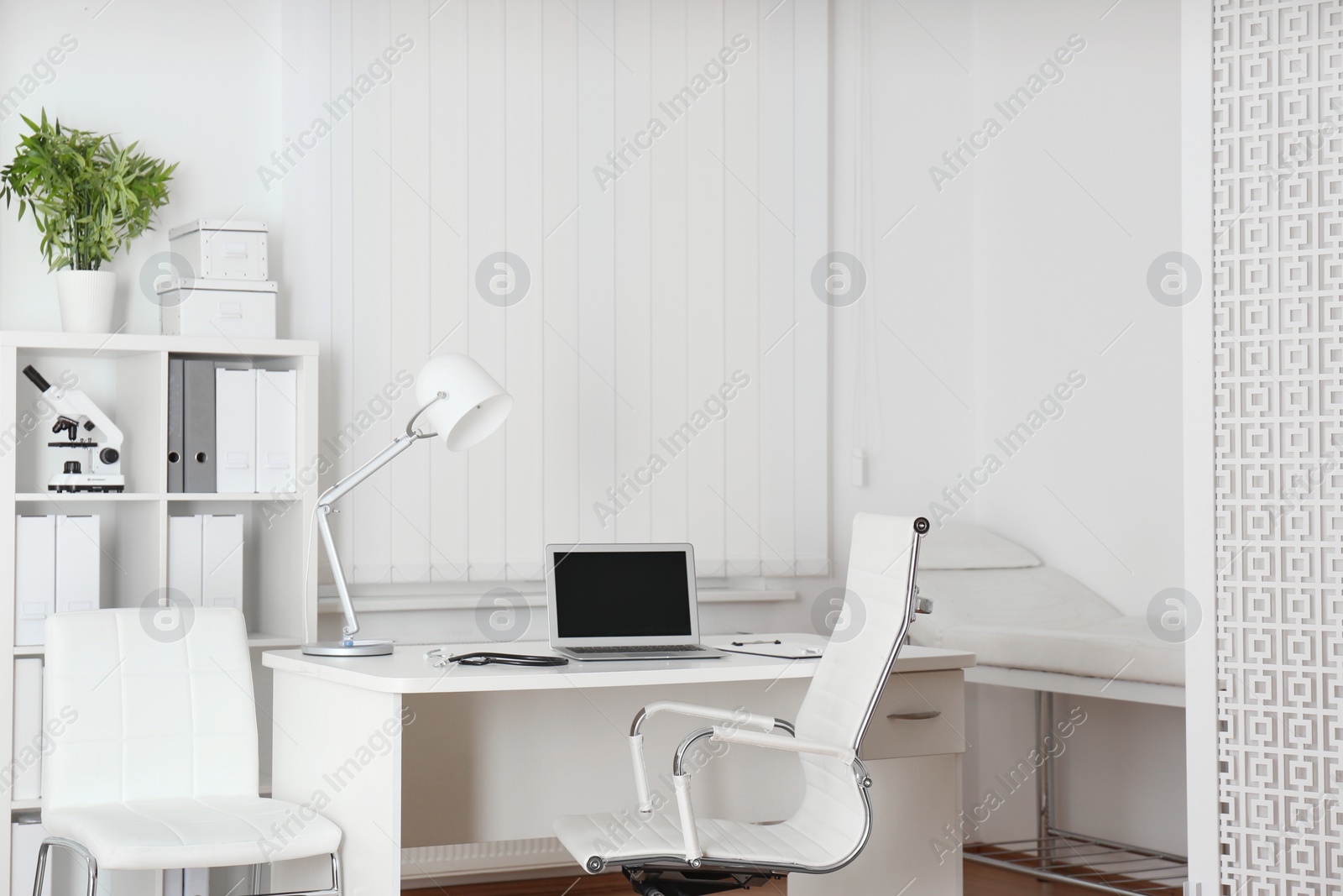Photo of Doctor's workplace with modern laptop in medical office