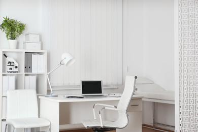 Doctor's workplace with modern laptop in medical office