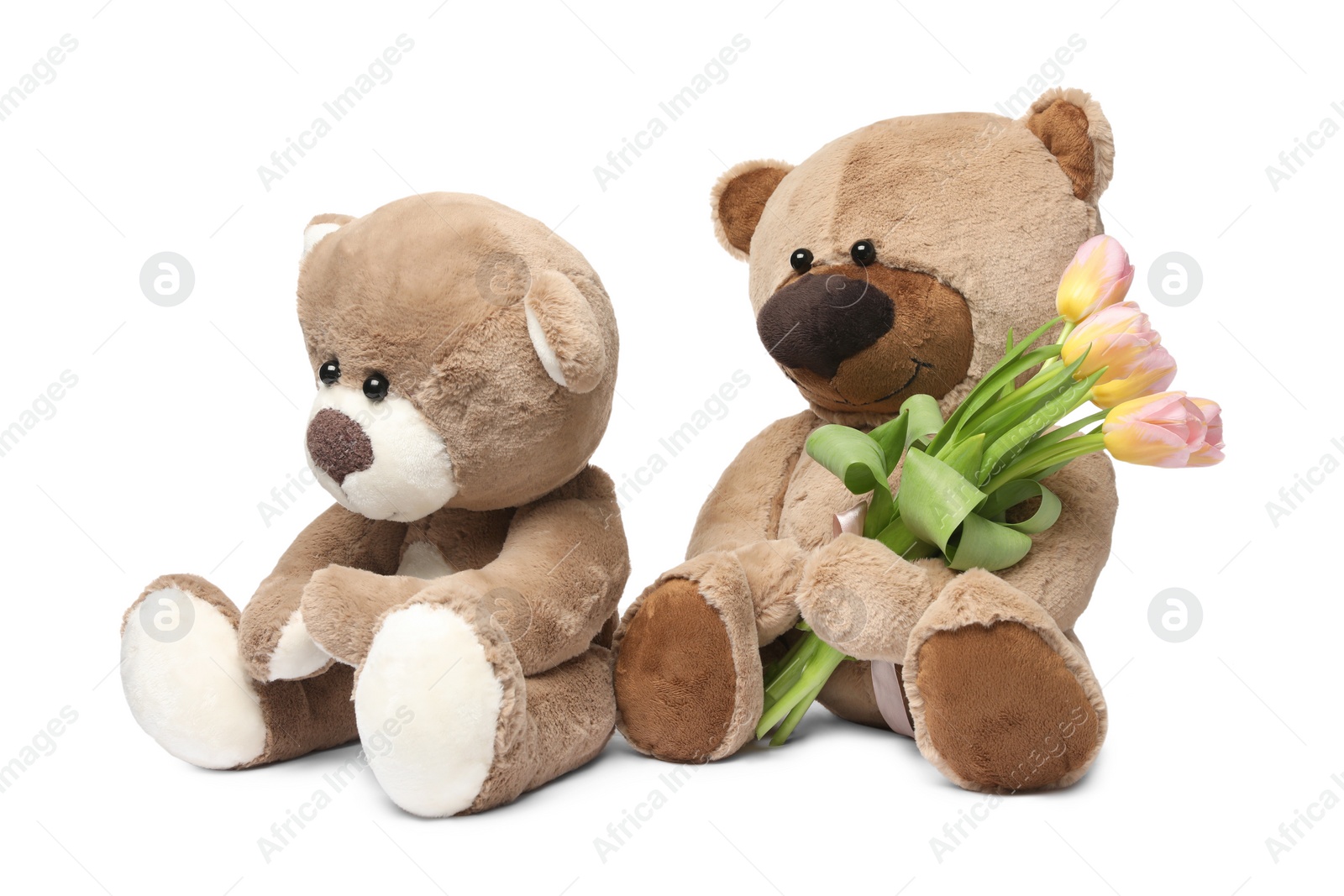 Photo of Cute teddy bears with beautiful tulips isolated on white