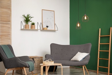 Photo of Modern living room interior stylish sofa near green wall