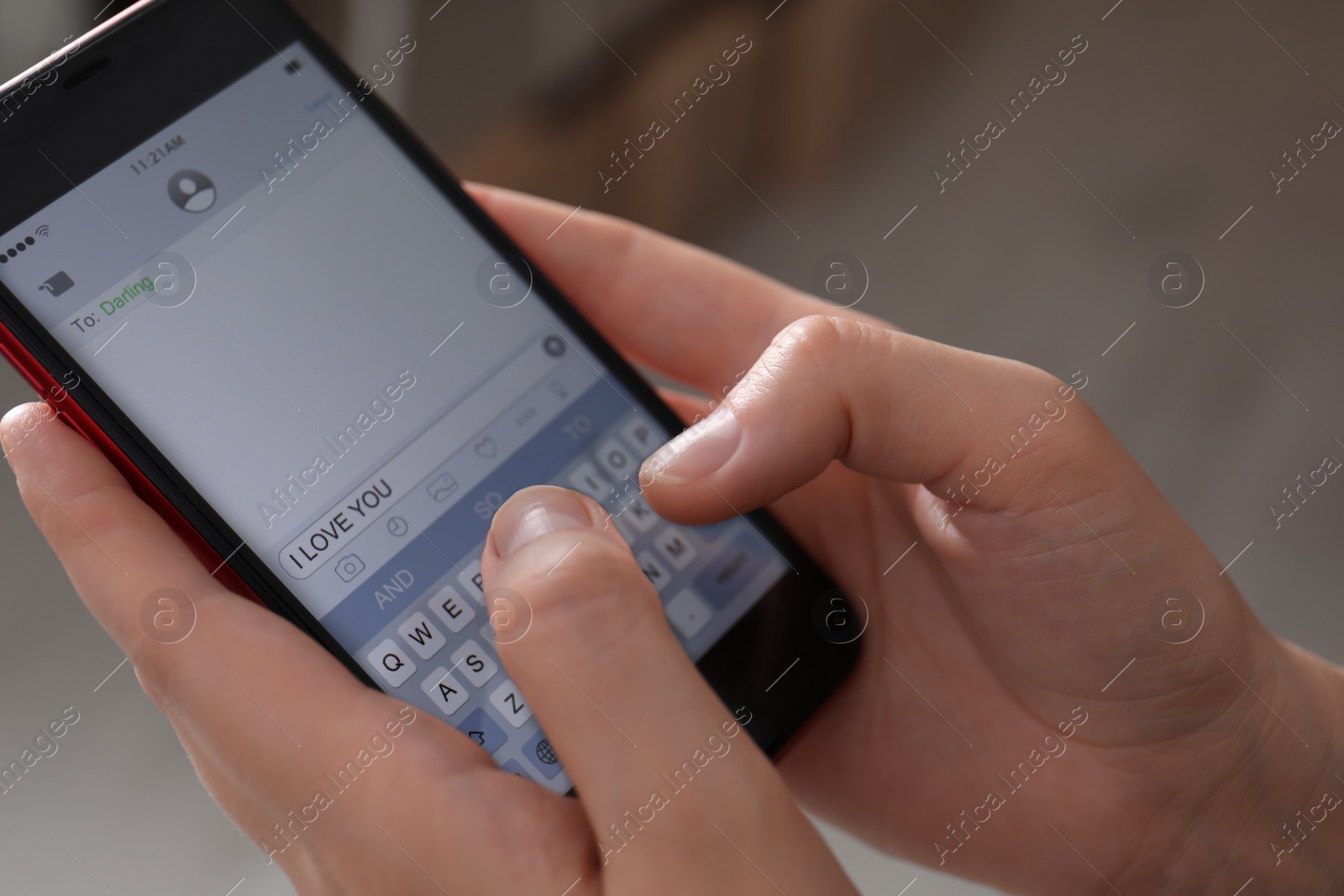 Photo of Woman sending message with text I Love You indoors, closeup