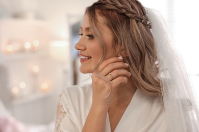 Photo of Happy bride with beautiful makeup and hairstyle at home. Wedding day