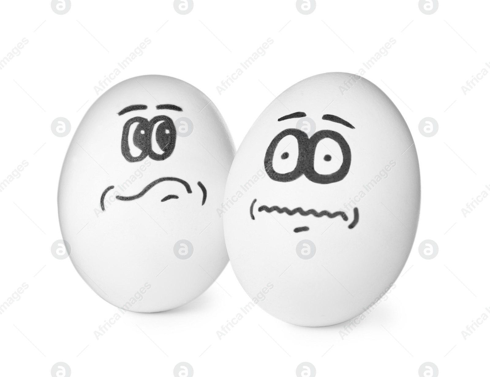 Photo of Eggs with drawn thoughtful and frightened faces on white background