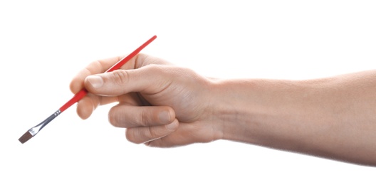 Photo of Man holding paint brush on white background, closeup