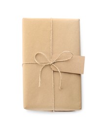 Parcel wrapped with kraft paper, twine and tag isolated on white, top view