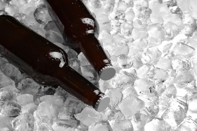 Photo of Bottles of beer on pile of ice cubes