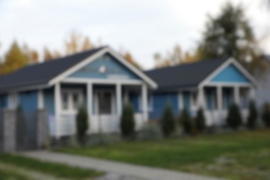 Photo of Blurred view of beautiful light blue houses outdoors. Real estate