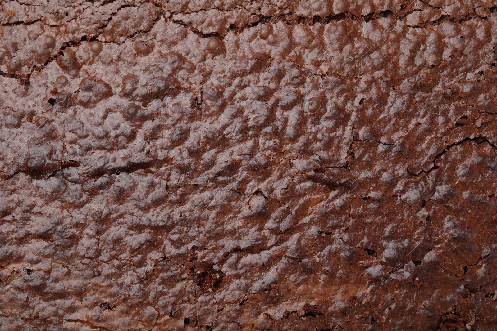 Photo of Closeup of delicious chocolate brownie as background, top view