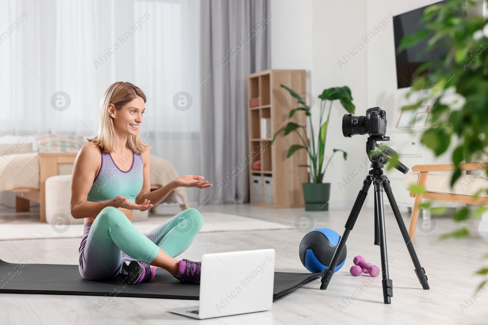 Photo of Fitness trainer recording online classes at home