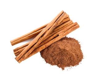 Photo of Aromatic cinnamon sticks and powder on white background, top view