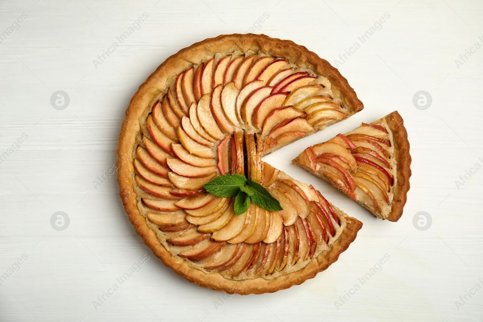 Photo of Delicious apple pie on white wooden table, flat lay