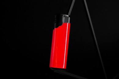 Stylish presentation of small pocket lighter on black background