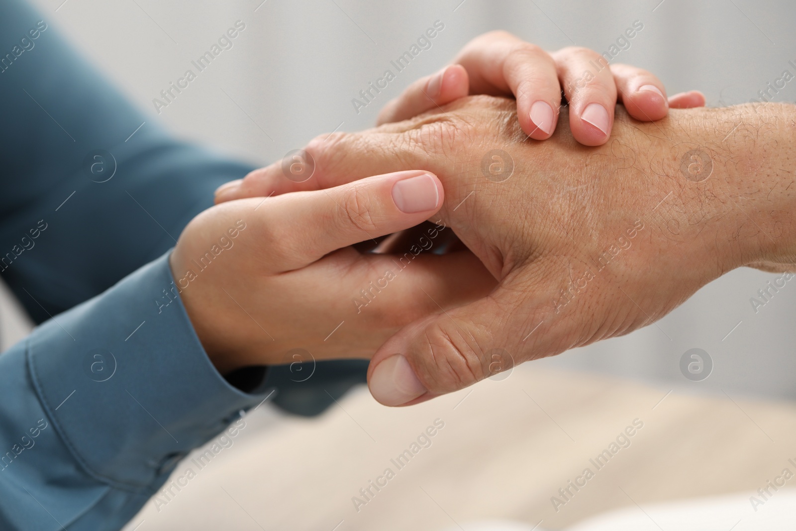 Photo of Trust and deal. Woman with man joining hands indoors, closeup