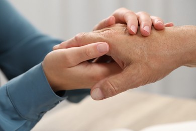 Photo of Trust and deal. Woman with man joining hands indoors, closeup