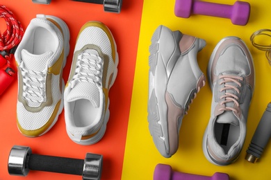 Flat lay composition of training shoes, dumbbells and jump ropes on color background