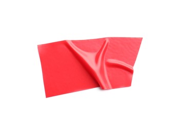 Photo of Piece of red insulating tape isolated on white, top view
