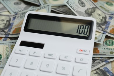 Money exchange. Dollar banknotes and calculator, closeup