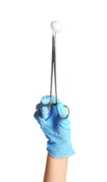Photo of Doctor in sterile glove holding medical clamp with cotton ball on white background