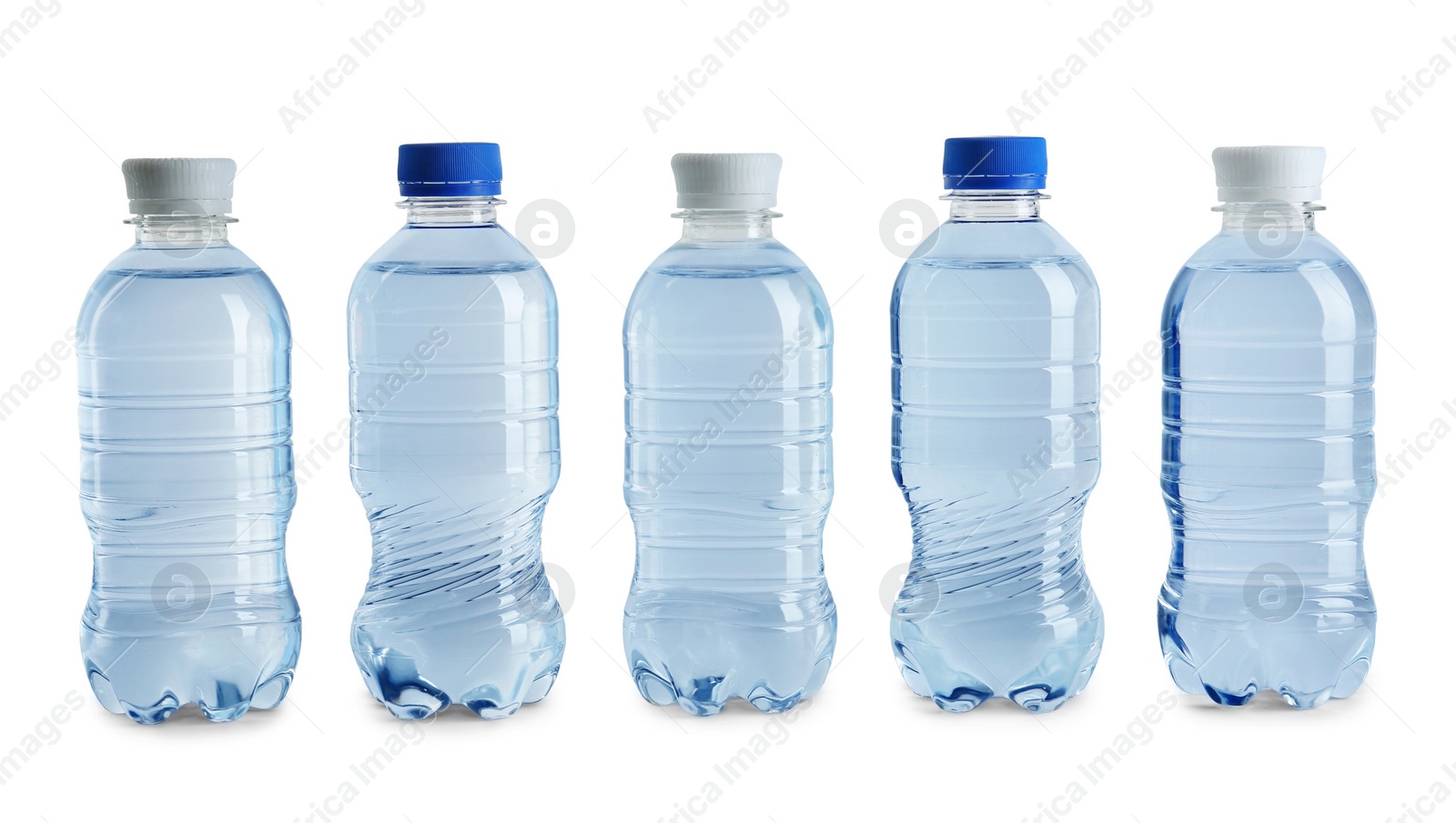 Photo of Row of different plastic bottles with water on white background