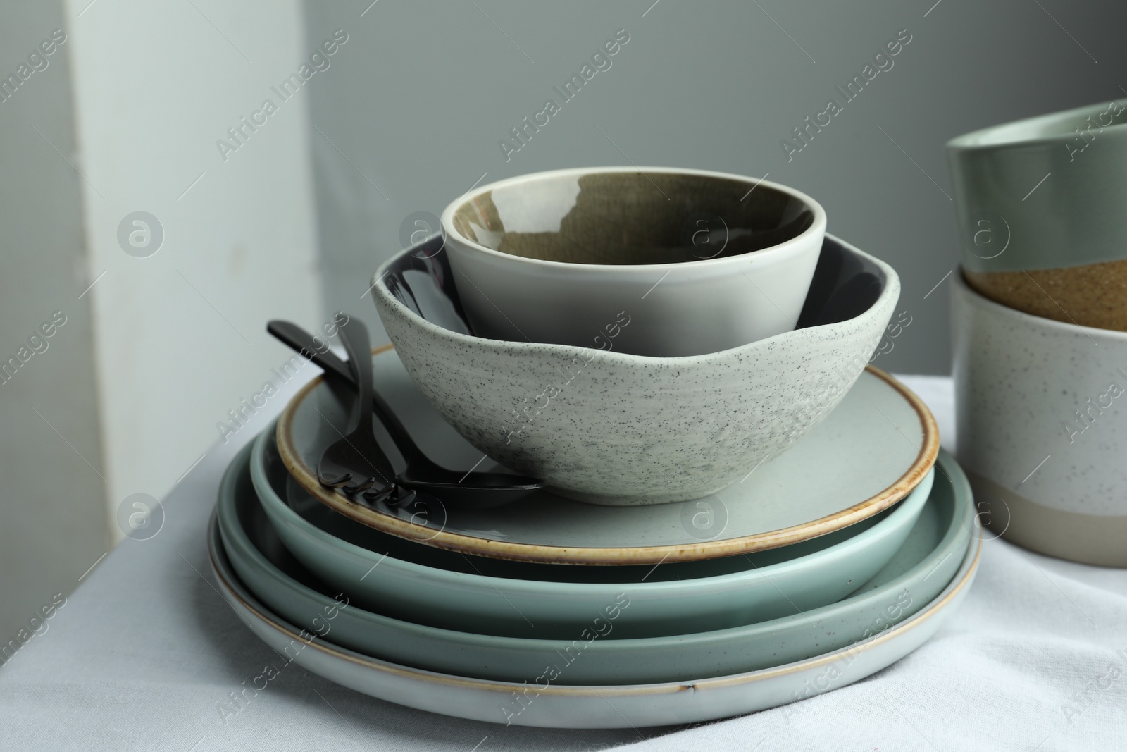 Photo of Stylish empty dishware and cutlery on table indoors