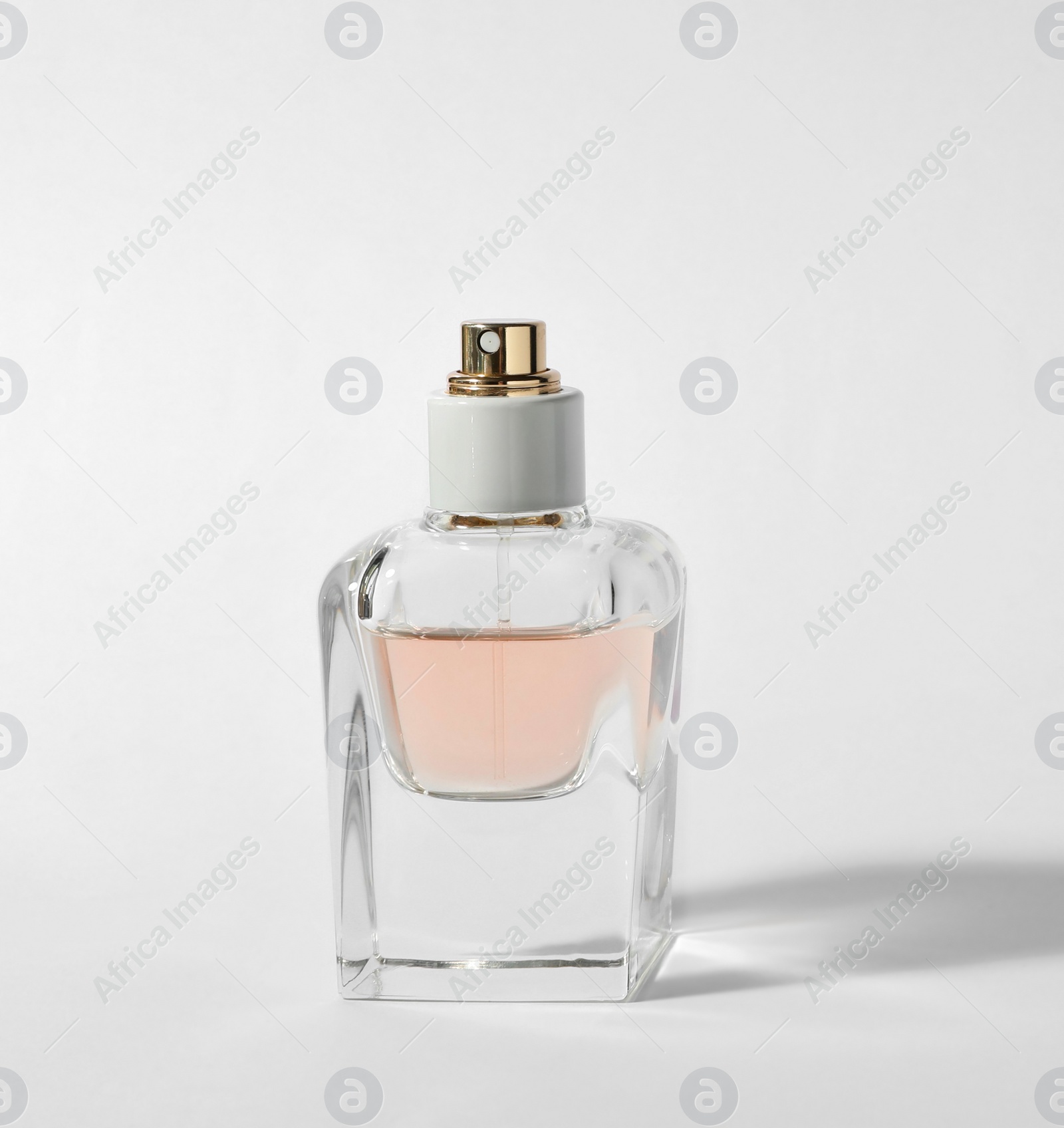 Photo of Bottle of perfume on light background