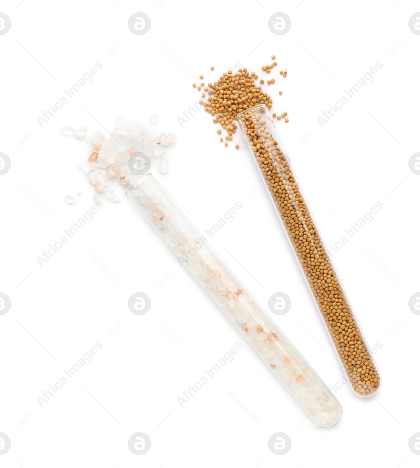 Photo of Glass tubes with pink himalayan salt and mustard seeds on white background, top view