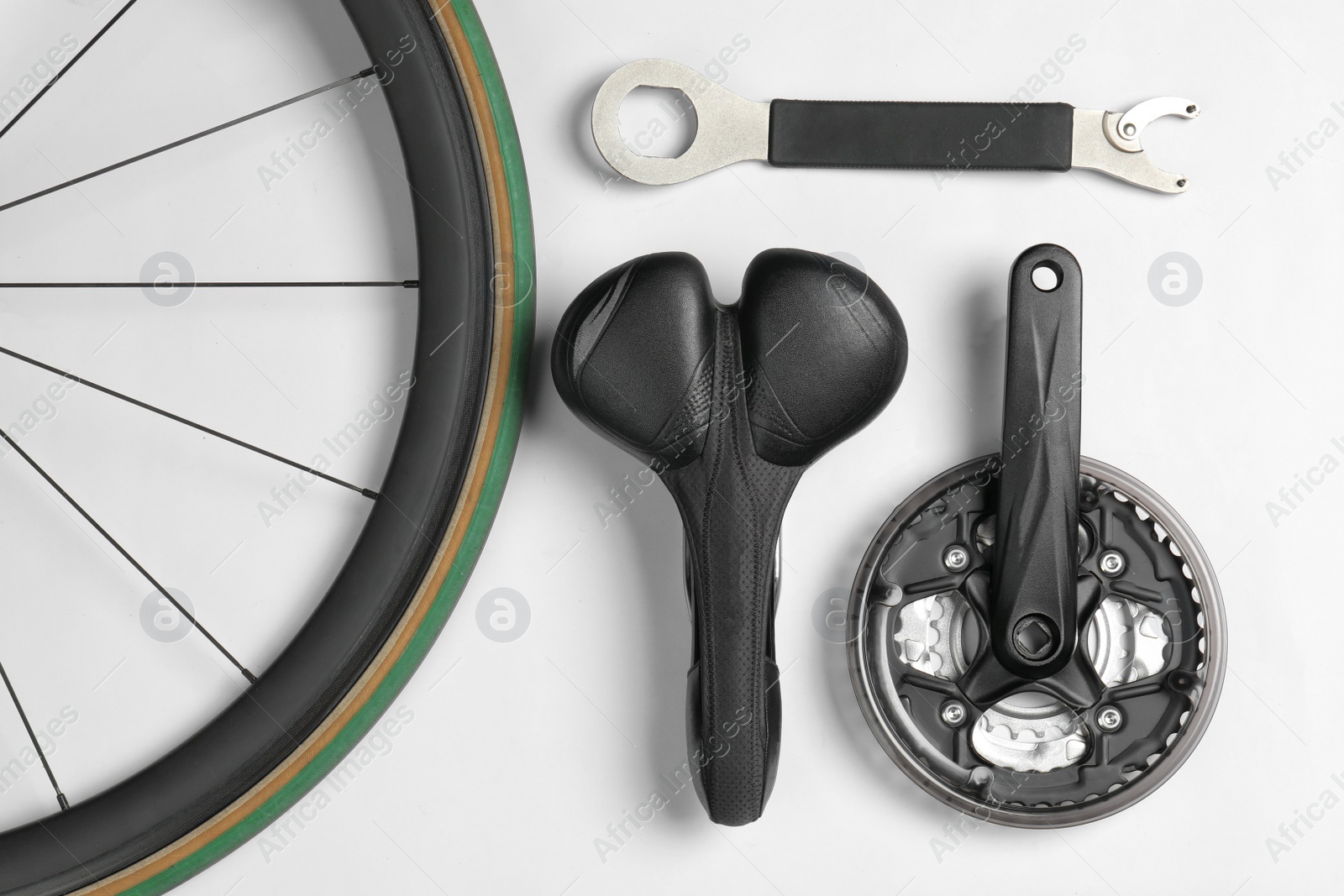 Photo of Set of different bicycle parts and tool on white background, flat lay