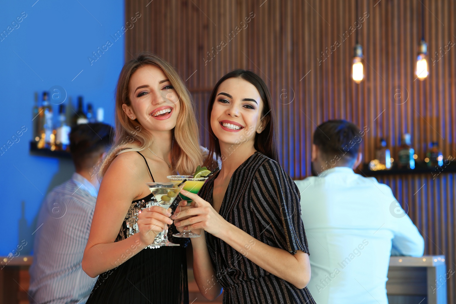 Photo of Beautiful young women with martini cocktails in bar