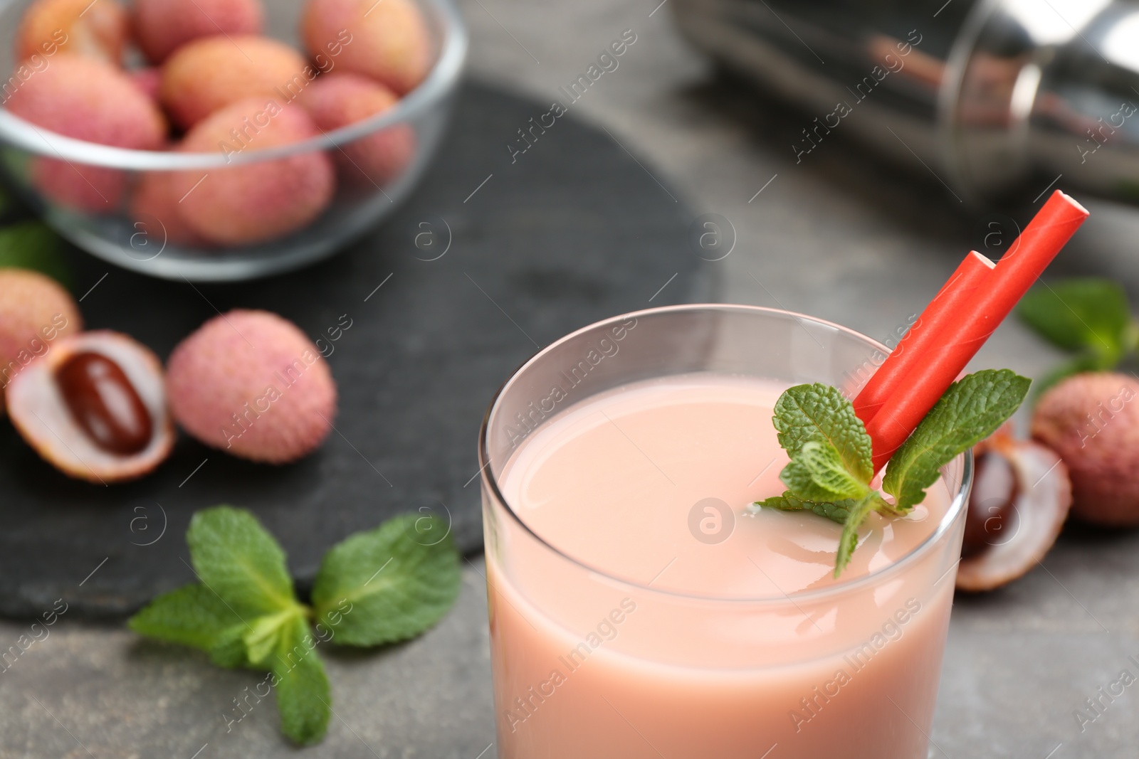 Photo of Tasty lychee cocktail on grey table, closeup