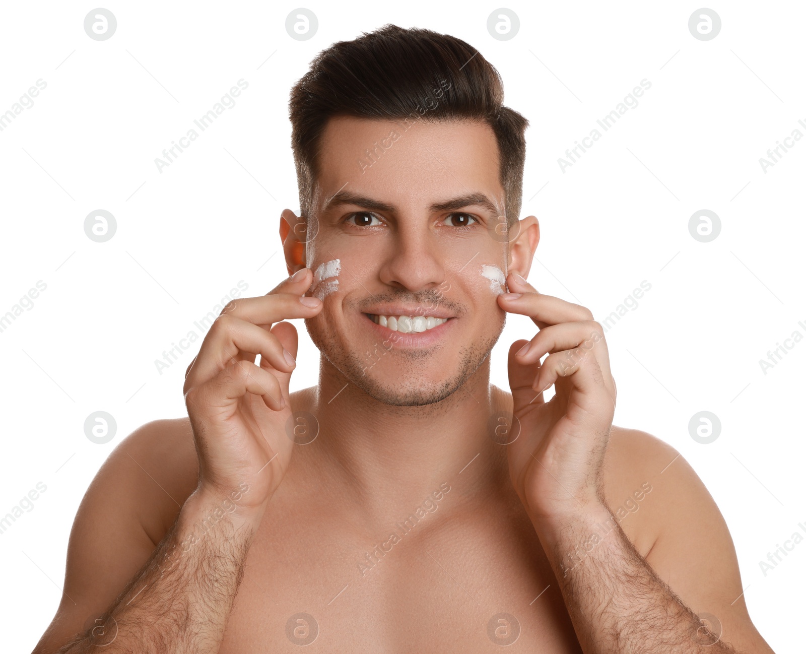 Photo of Handsome man applying face cream on white background