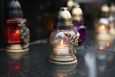 Photo of Grave lights on granite surface at cemetery