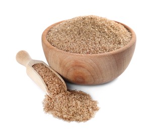 Wooden bowl and scoop with brown salt on white background