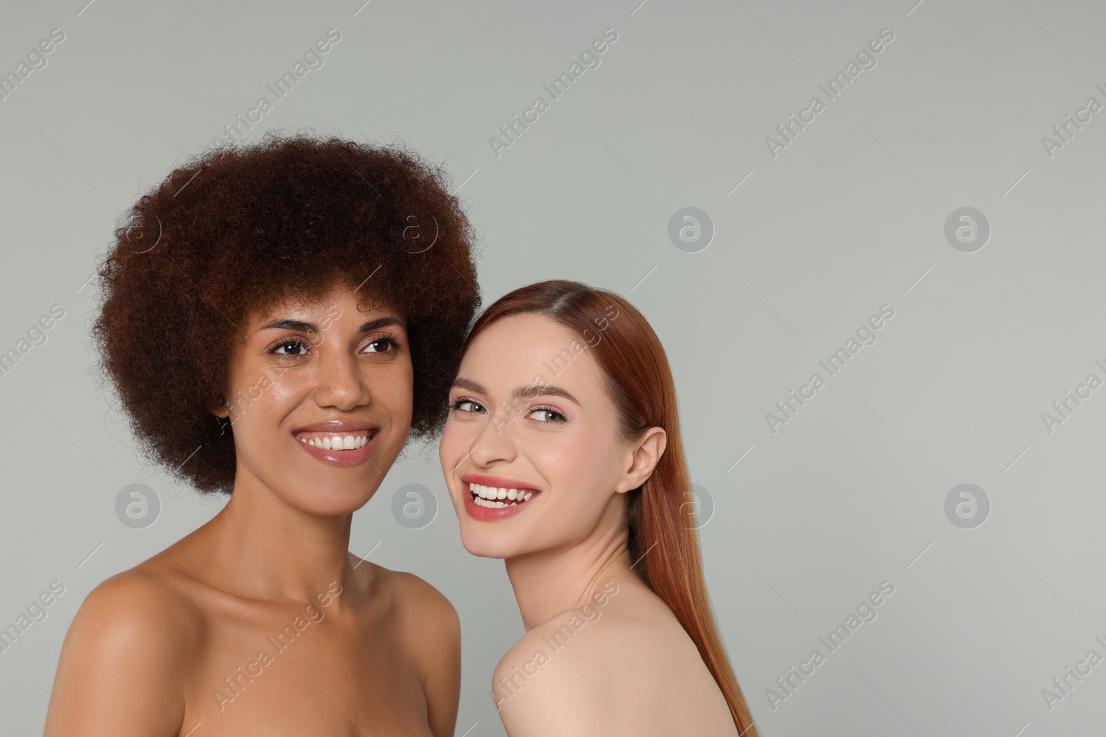 Photo of Portrait of beautiful young women on light grey background. Space for text