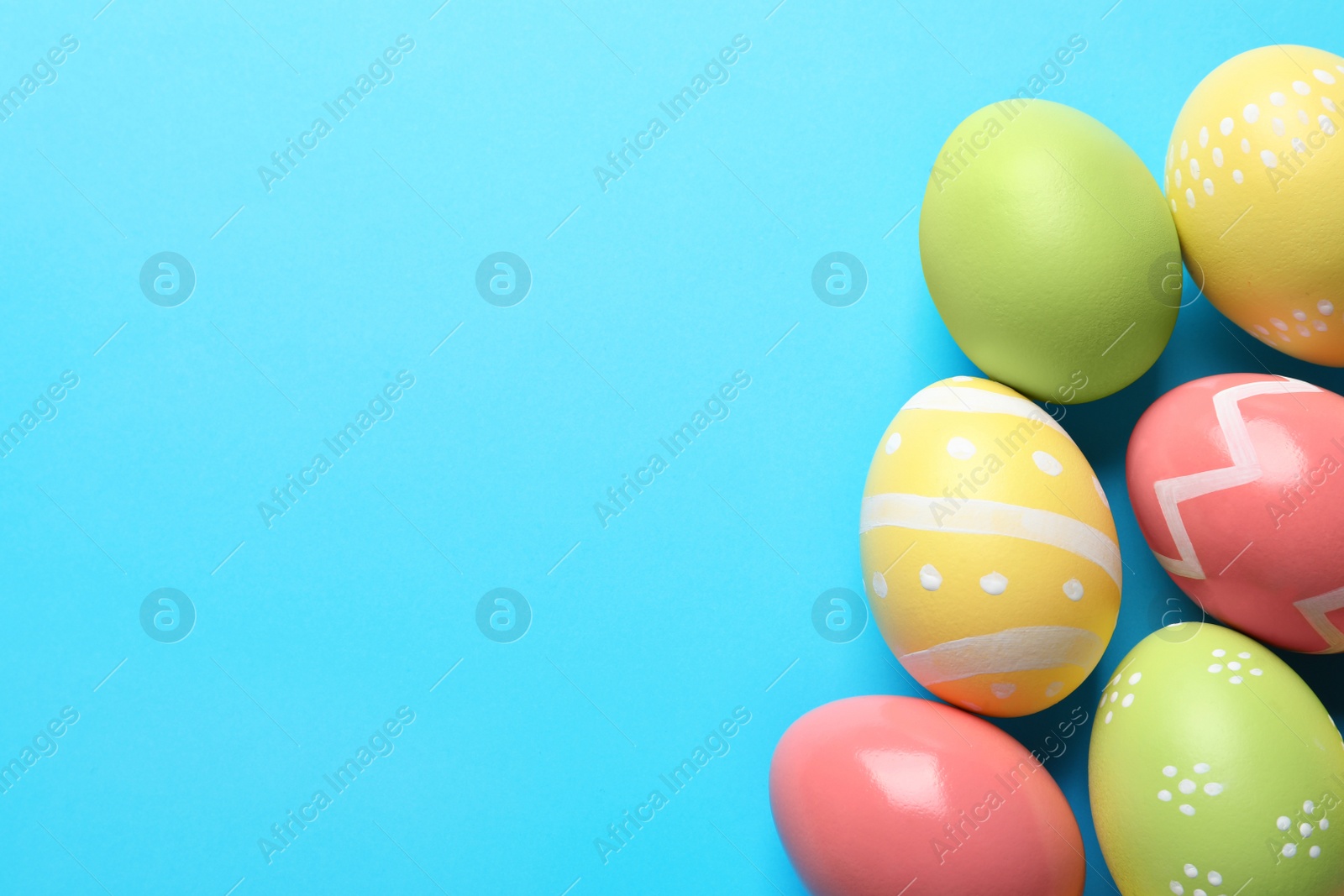 Photo of Beautiful painted Easter eggs on color background, flat lay. Space for text