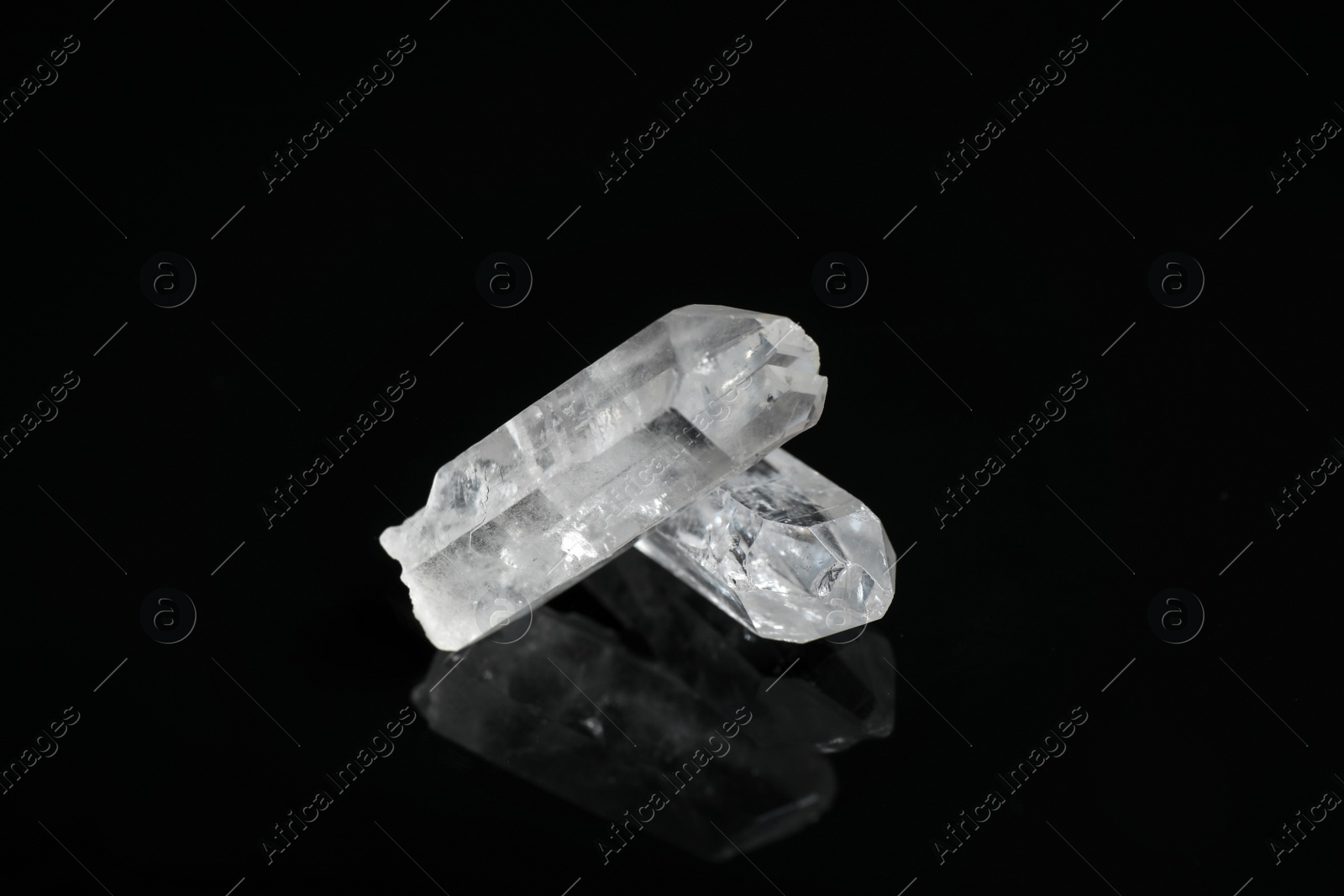 Photo of Beautiful rock crystal gemstones on black background