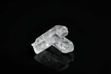 Photo of Beautiful rock crystal gemstones on black background
