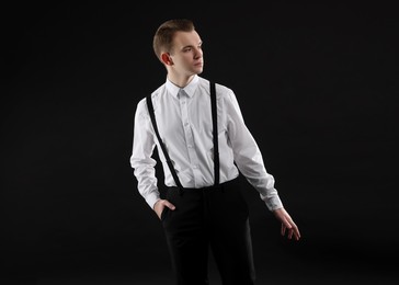 Photo of Handsome young man in white shirt on black background