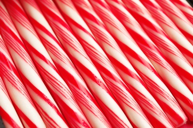 Photo of Many candy canes as background. Festive treat