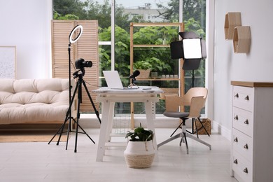 Photo of Modern blogger's workplace with professional equipment and laptop in room